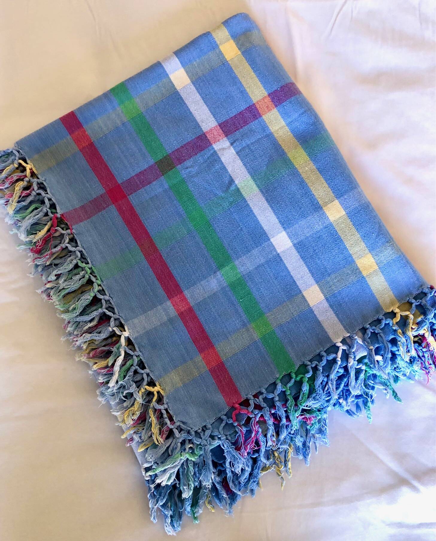 Vintage tablecloth & napkins, blue with multicoloured stripes.
