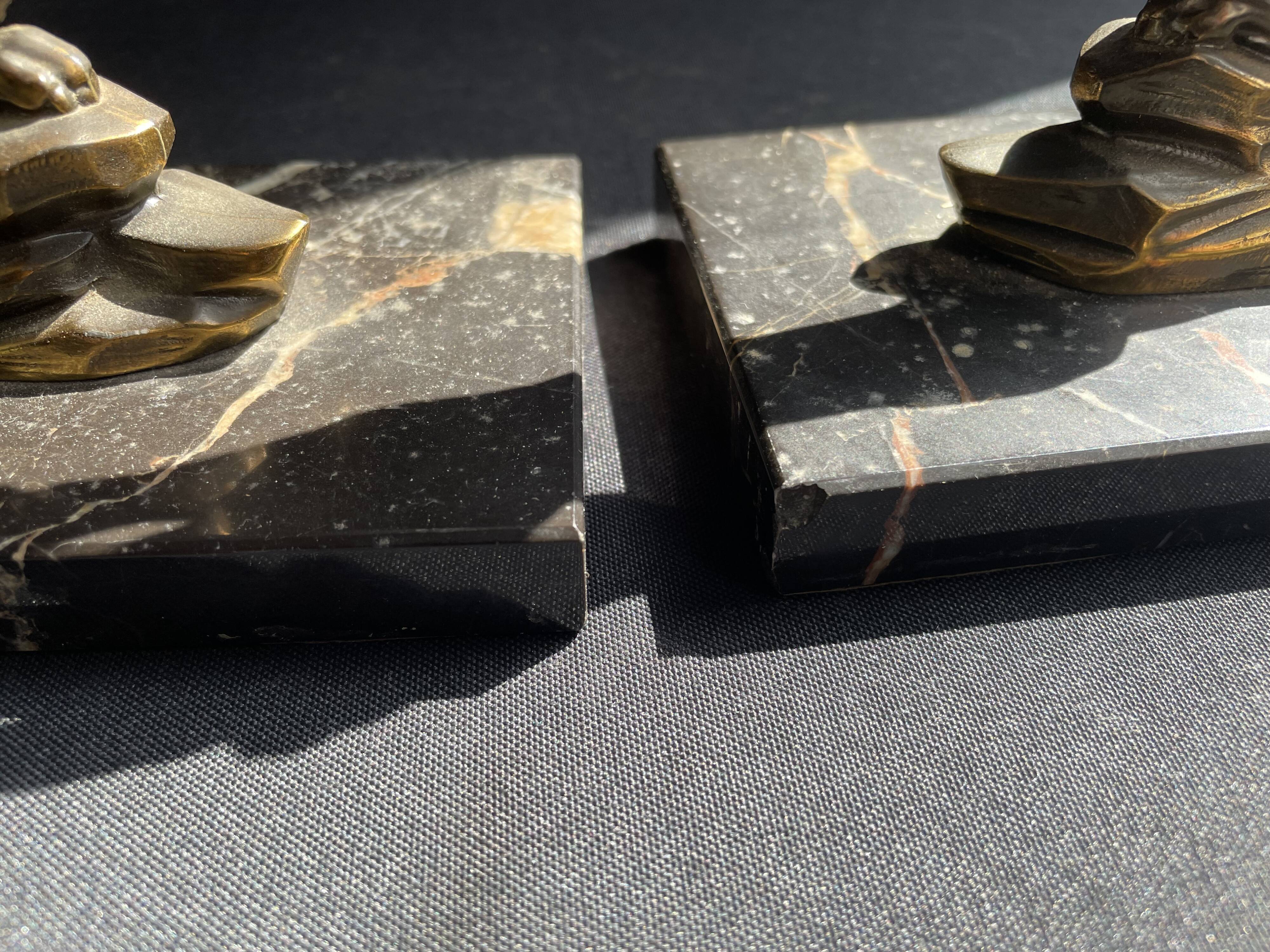 Pair of art deco marble and patinated regulated bookends