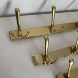 Three vintage 1960s gold coat racks 4, 3 and 2 hooks