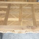Walnut table, two extensions, parquet top, carved crosspiece