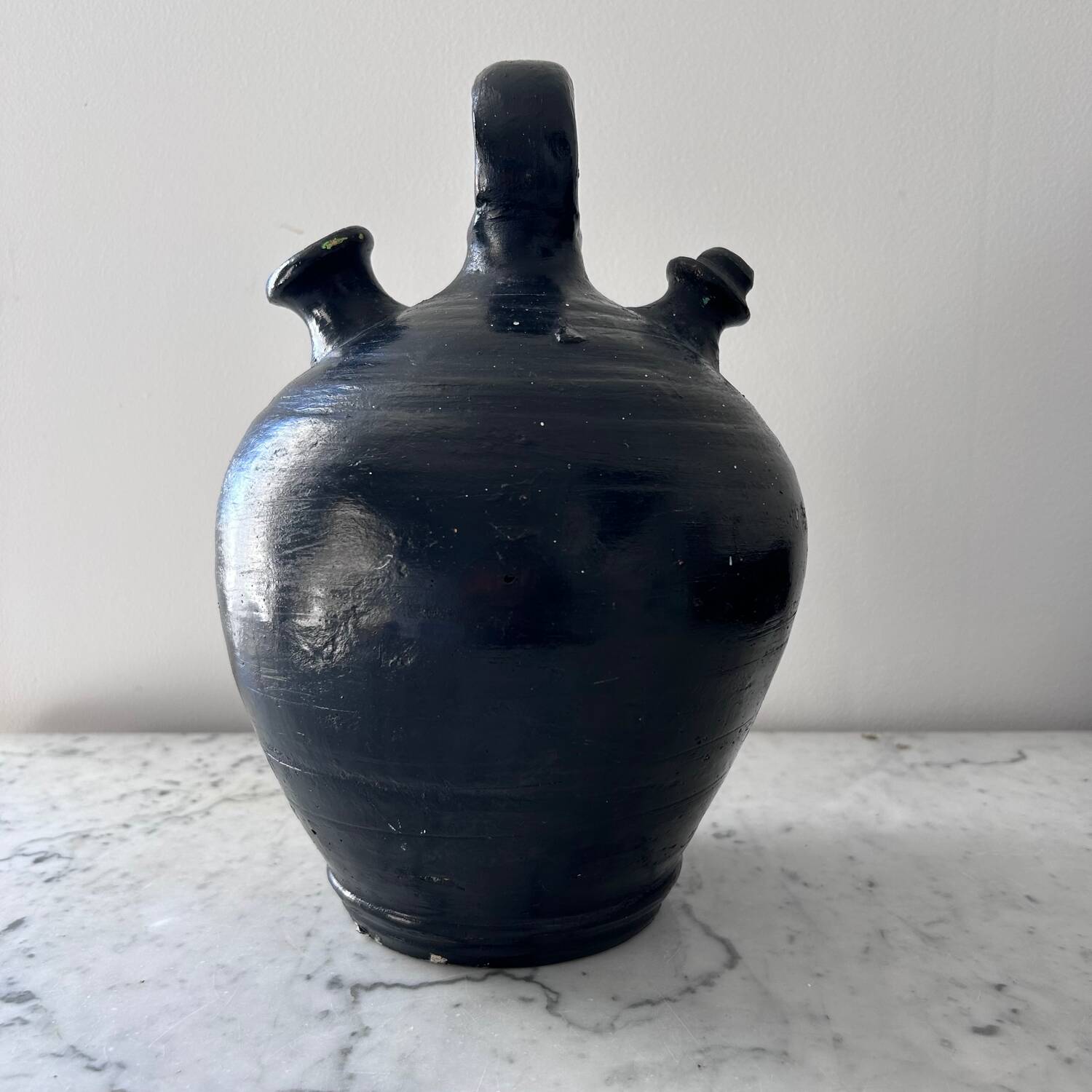 Black water jug with floral decoration
