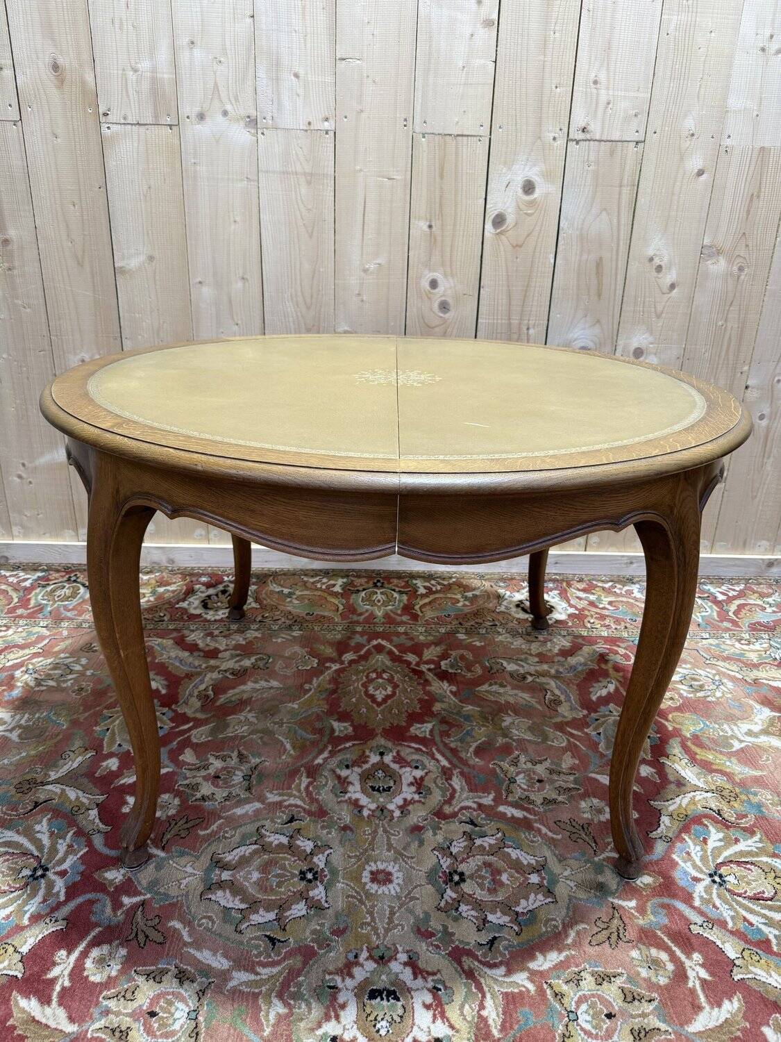 Round oak dining table with leather in Louis XV style.