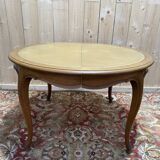 Round oak dining table with leather in Louis XV style.