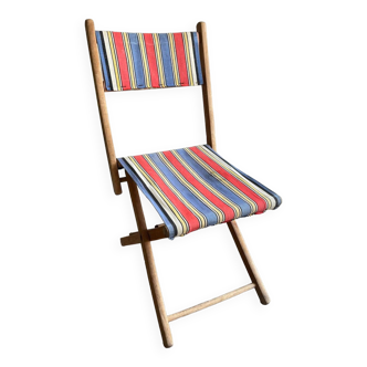 Old folding chair in wood and fabric