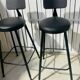 Pair of black bar stools in industrial and contemporary style.