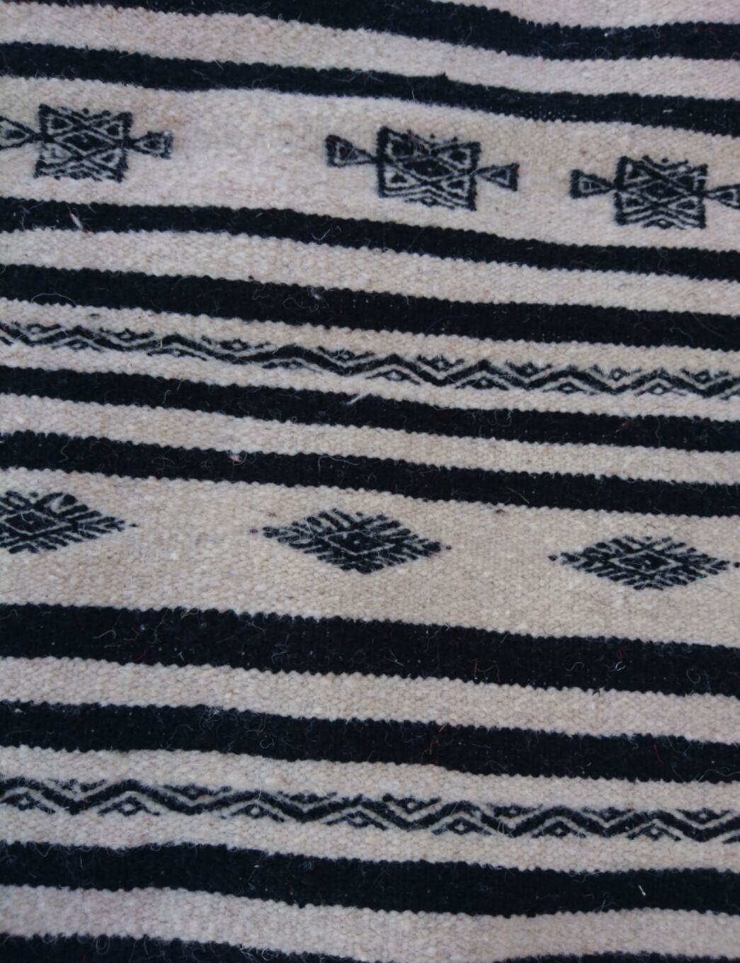 Beige and black handmade carpet, 110x55cm