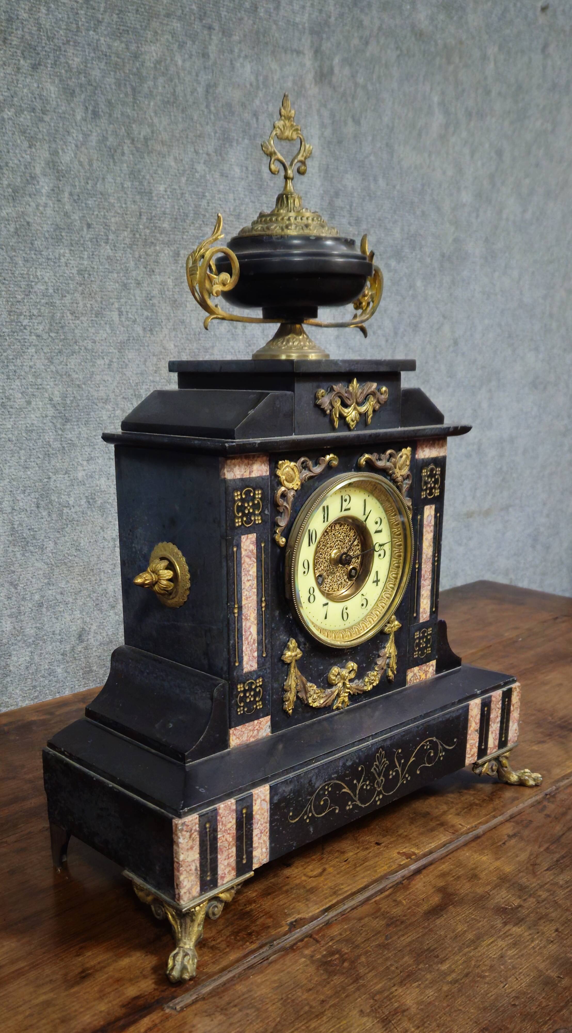 Large notary clock in black marble and gilded bronze.
