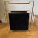 Gold metal, wood and black cotton magazine holder