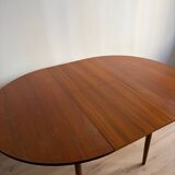 Vintage Scandinavian round table from the 50s and 60s in extendable teak with ra.