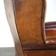 Very large worn sheepskin wing chair with a checked seat cushion
