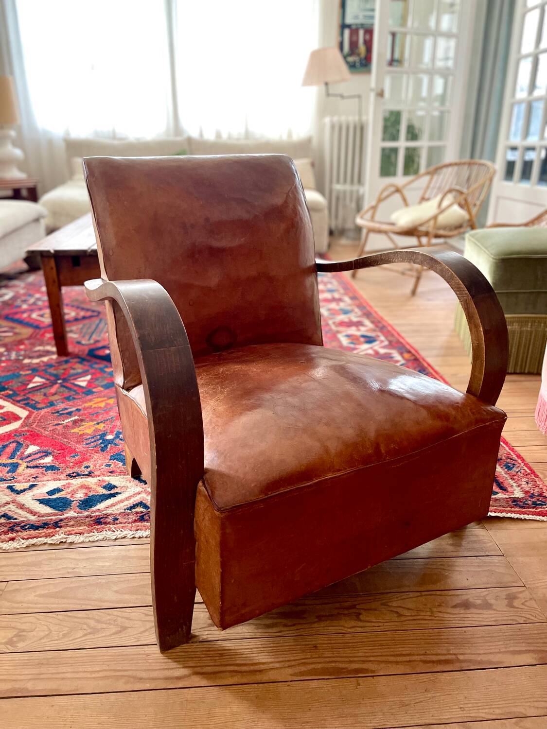 Vintage leather club chair with wooden armrests