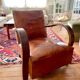 Vintage leather club chair with wooden armrests