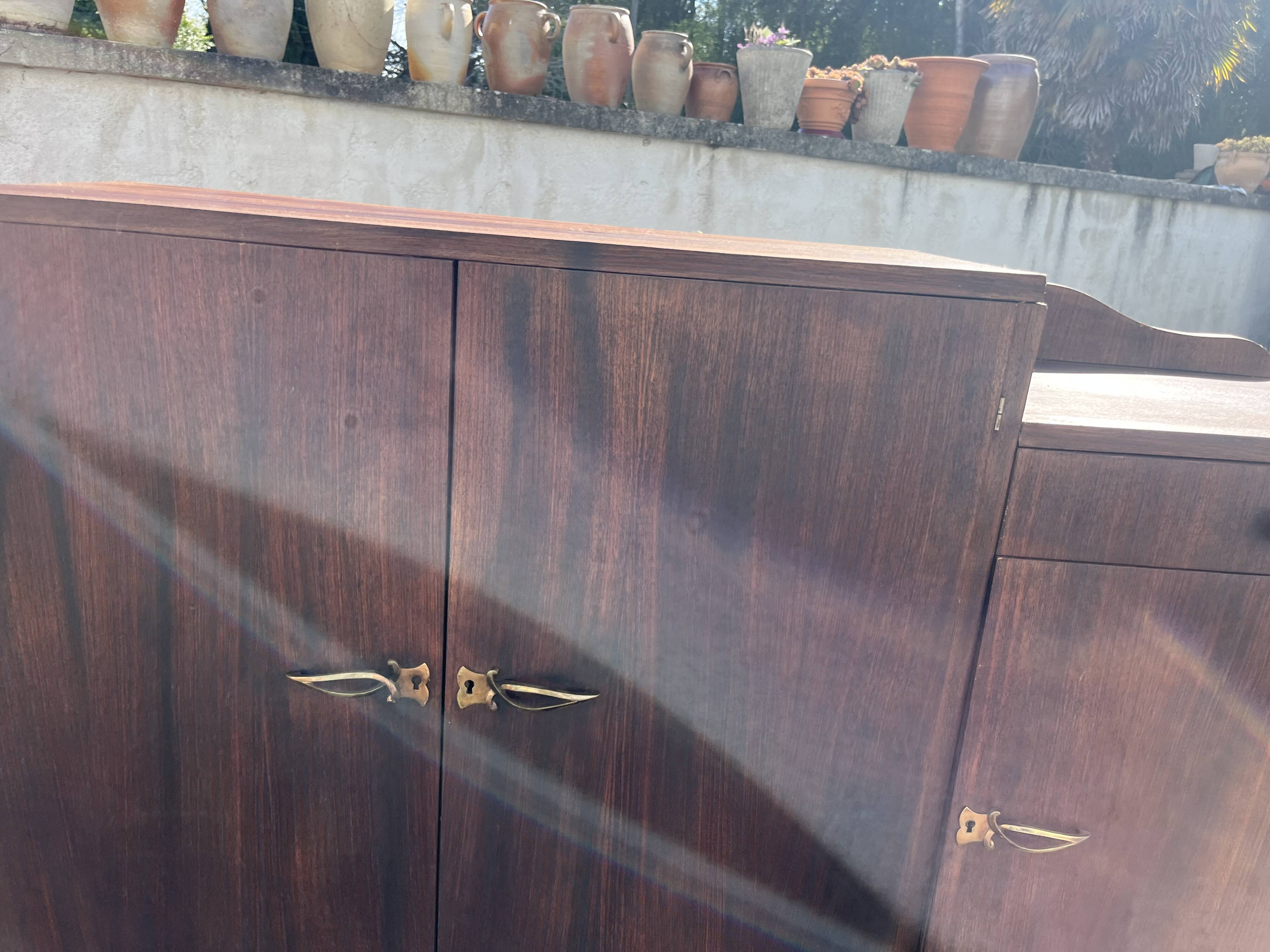 Asymmetrical antique Art Deco sideboard in rosewood veneer.