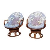 Pair of swivel rattan armchairs with removable cushion
