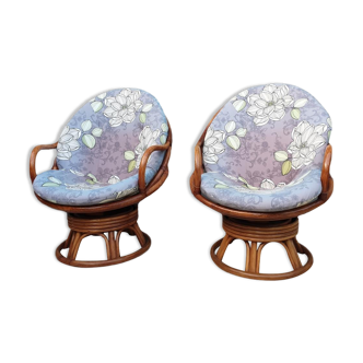 Pair of swivel rattan armchairs with removable cushion