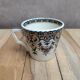 Antique ironstone cup from Sarreguemines with polychrome decoration.