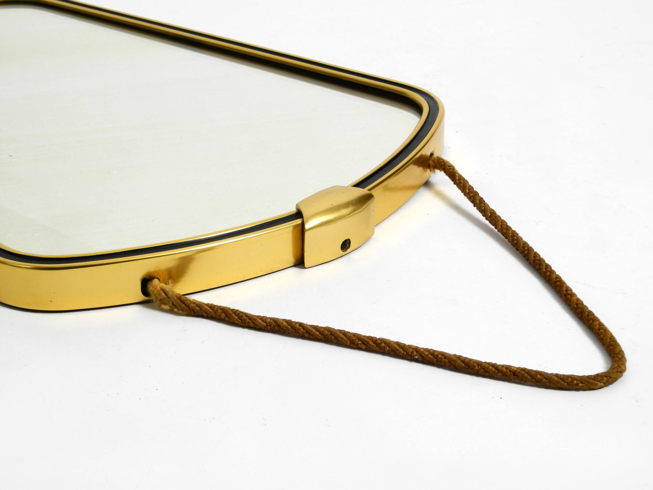 Beautiful small mid-century brass wall mirror with braided hanging strap