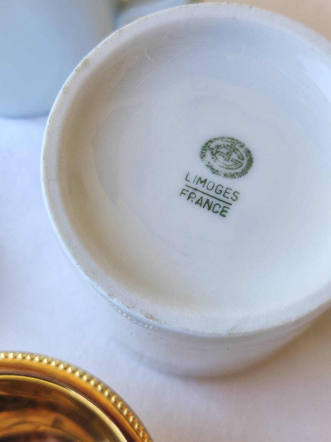 2 white and gold Limoges porcelain tea cups