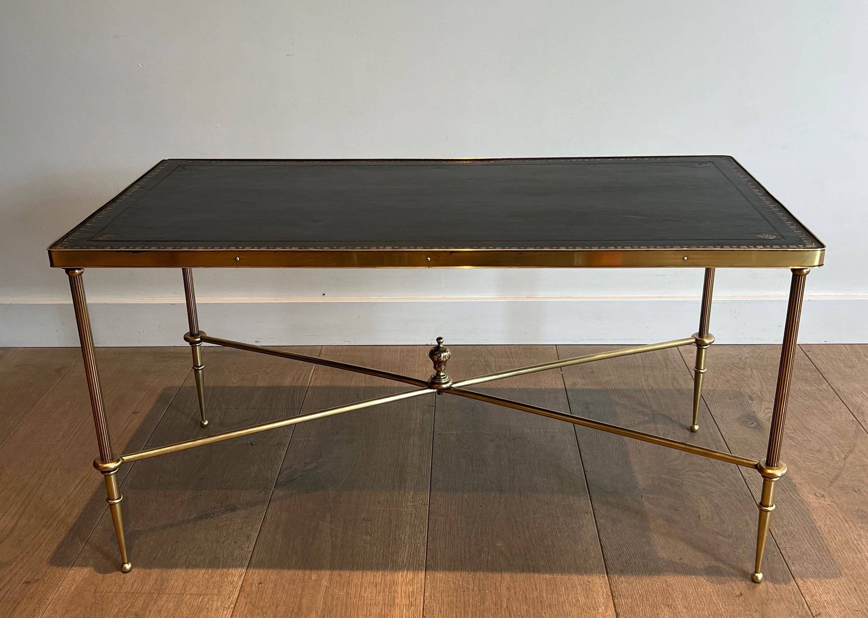 Neoclassical brass coffee table with a black leather top and golden borders from Maison Jansen.