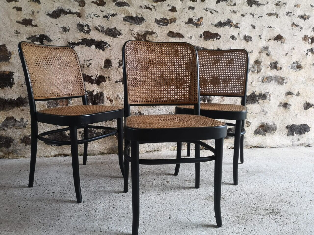 Blackened wooden chairs and cannage around 1980