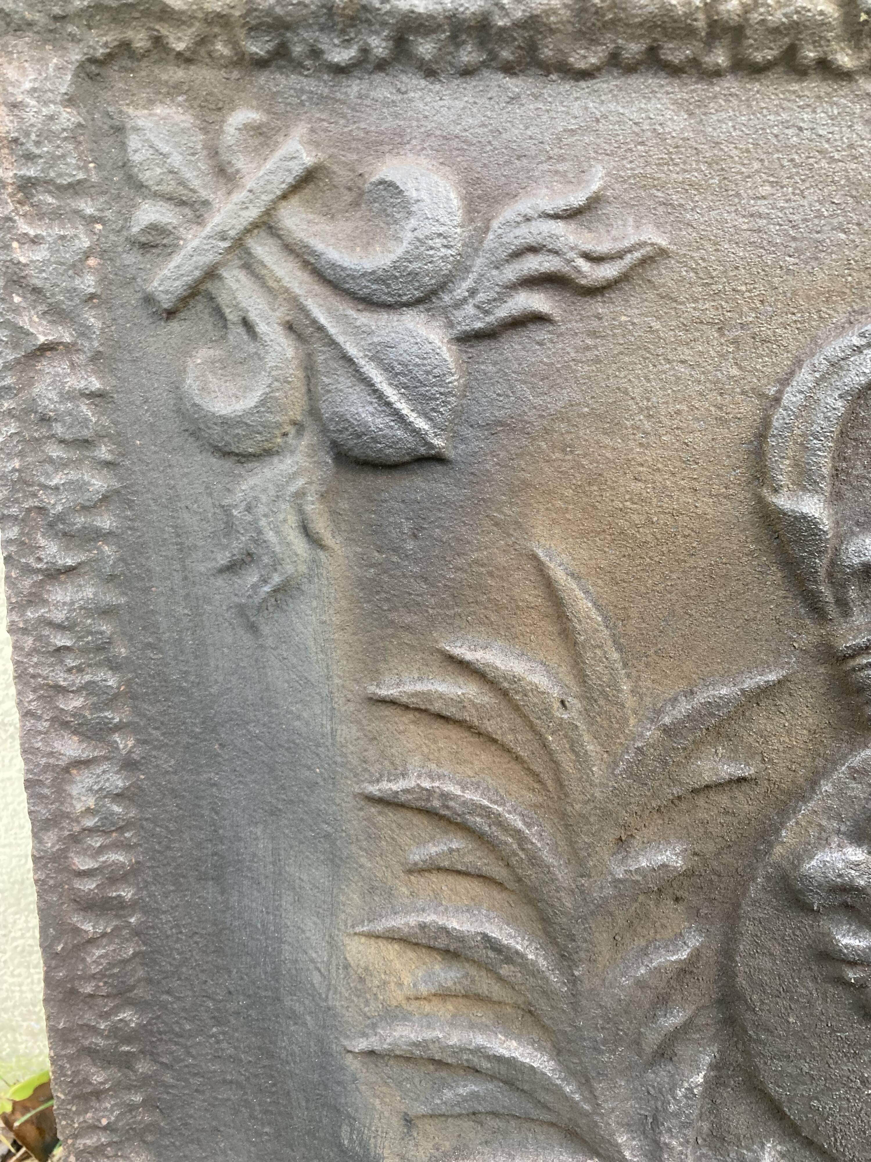 Old cast iron fireback with royal coat of arms