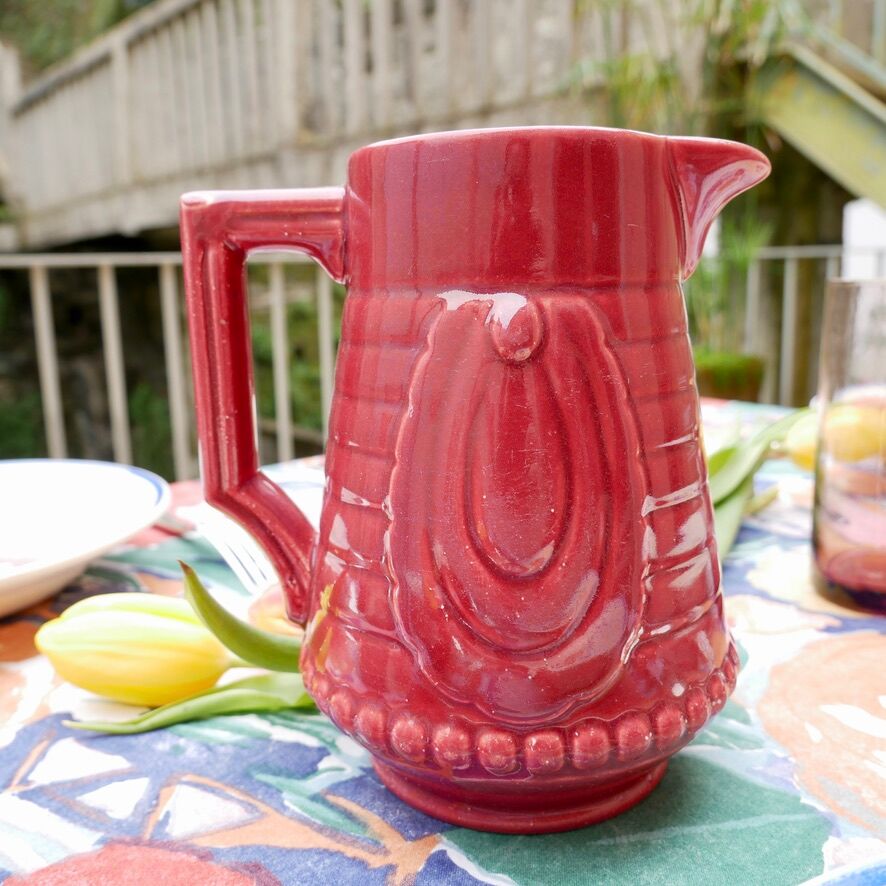 Burgundy/red ceramic pitcher