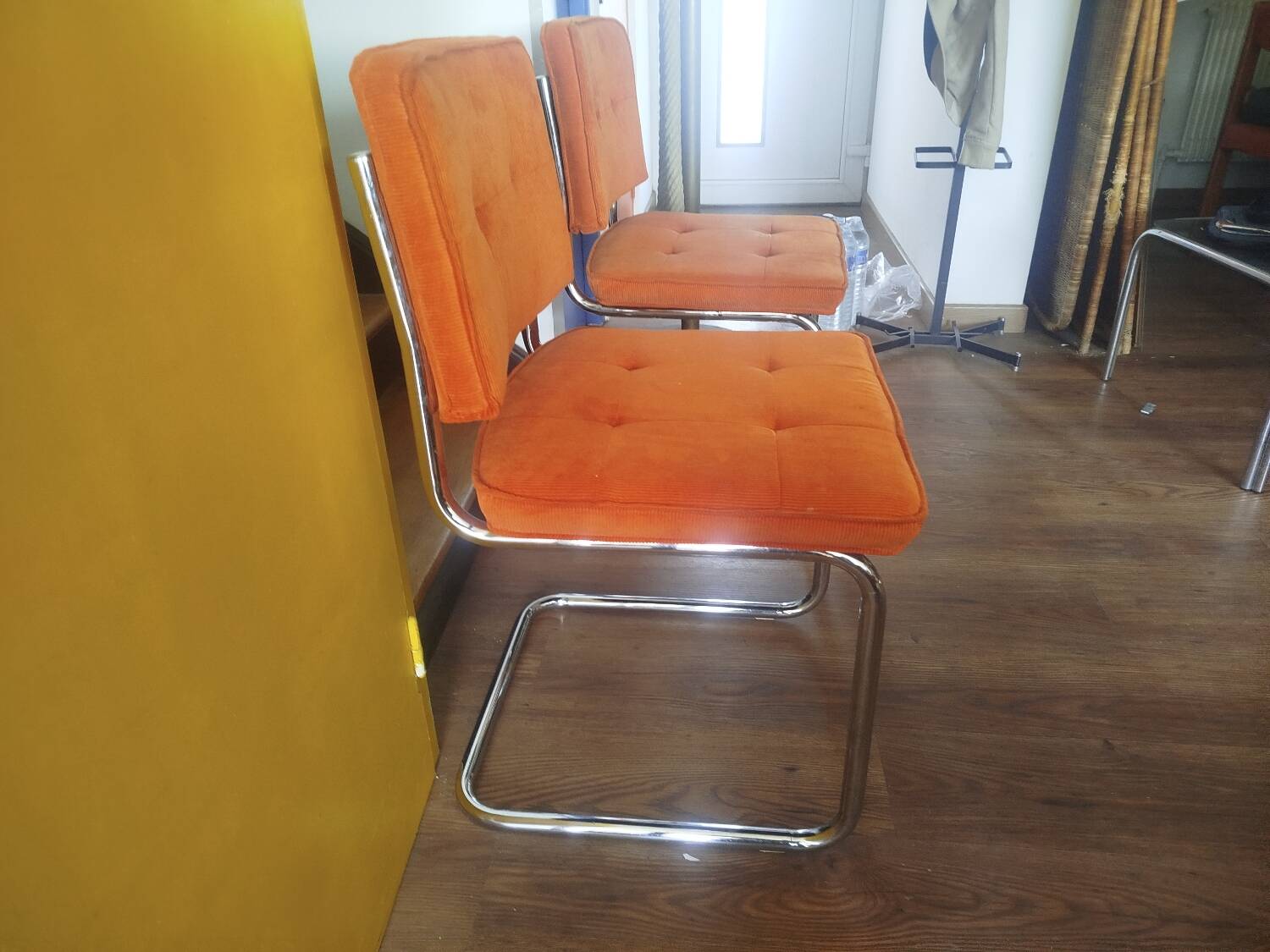 Pair of vintage cantilever chairs in chrome and orange corduroy.