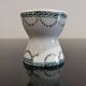 Old porcelain diabolo egg cup decorated with green frieze and garlands