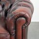 Classic cowhide Chesterfield sofa in English style with red/brown colours