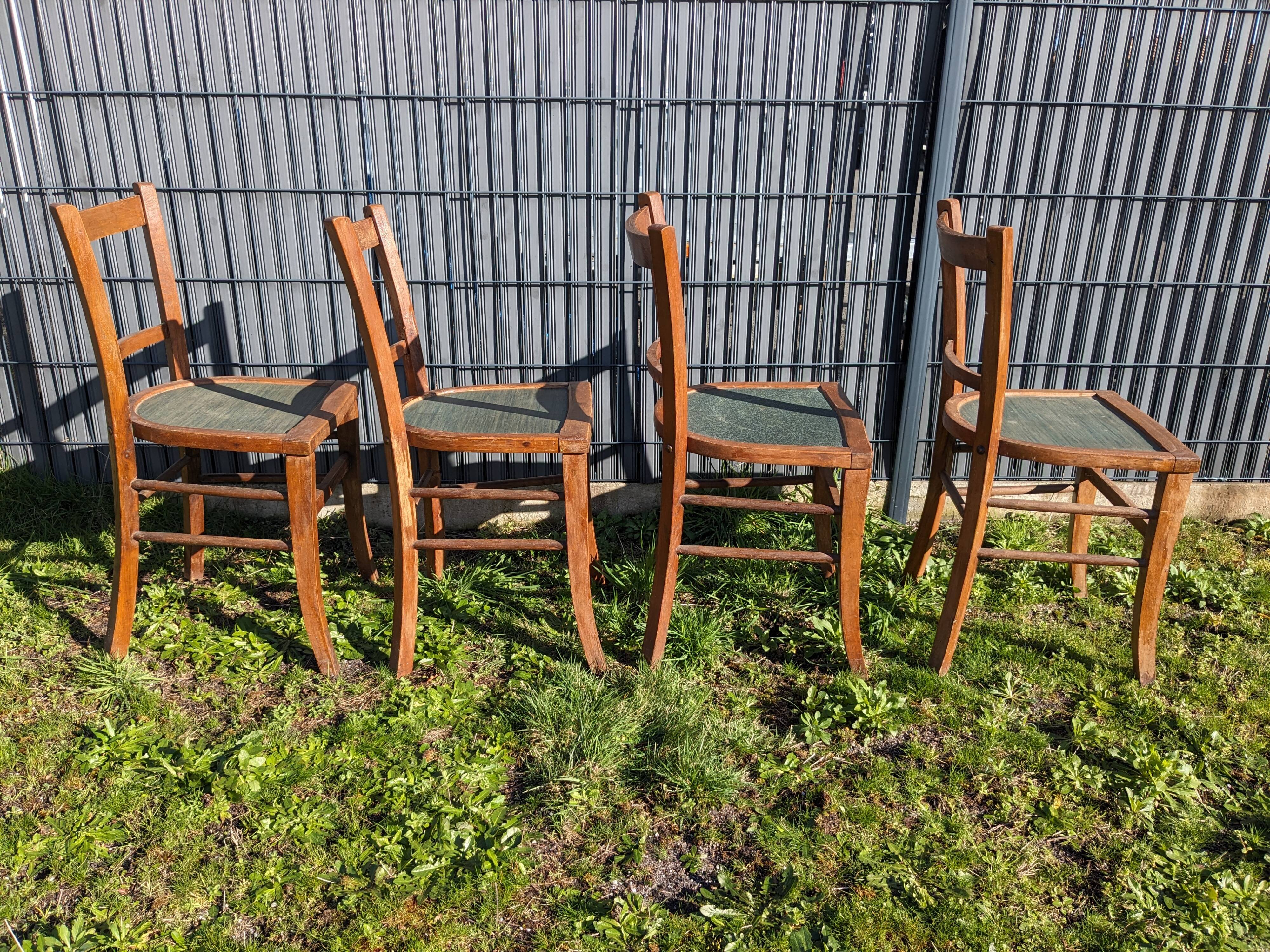 Set of four wooden bistro chairs, green seat, mid-20th century.