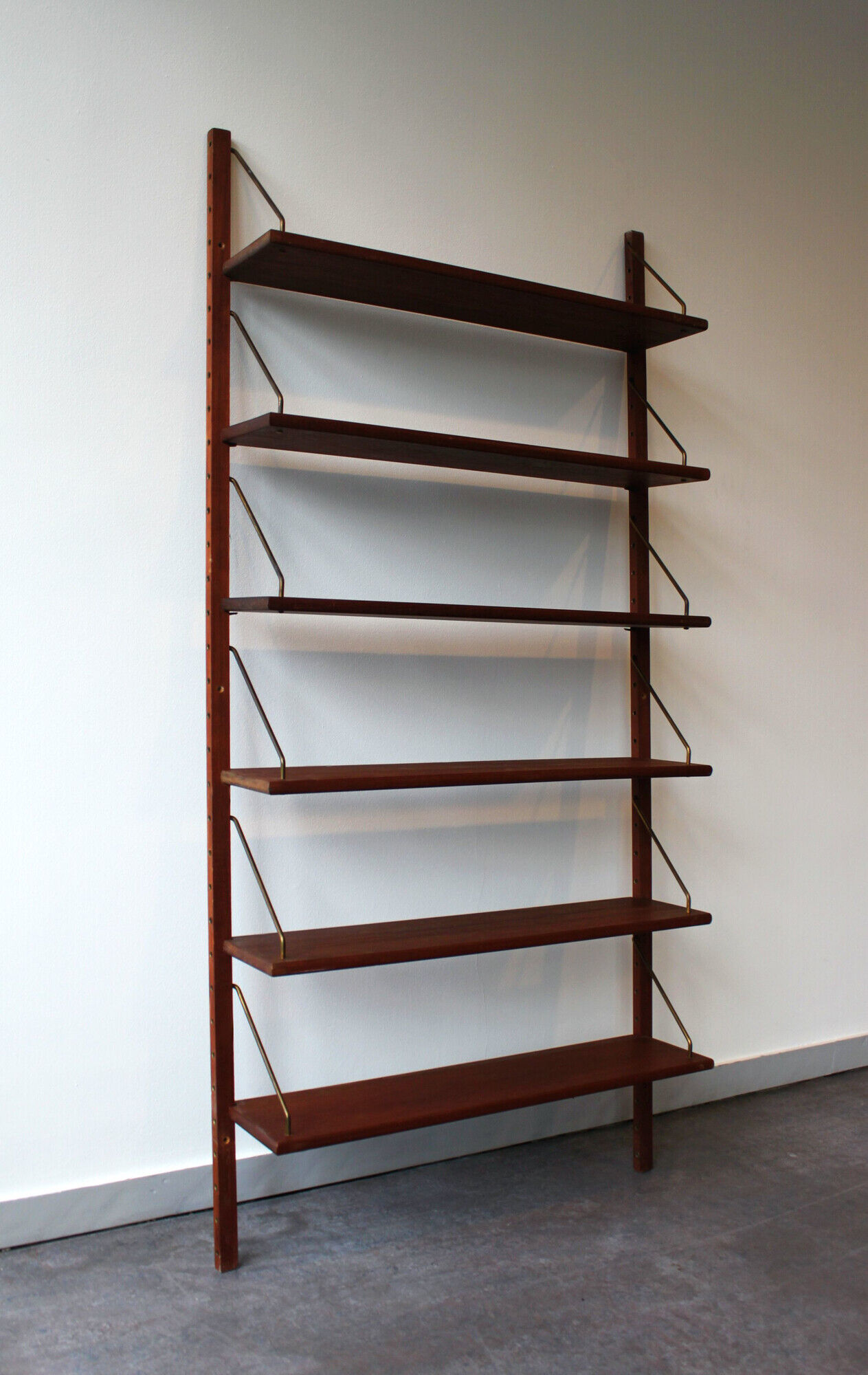 Teak and brass wall shelf by Poul Cadovius for Royal System, Denmark, 1960.