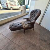 Chesterfield armchair with folding footrest