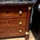 Empire chest of drawers with half columns in mahogany and gilded bronze