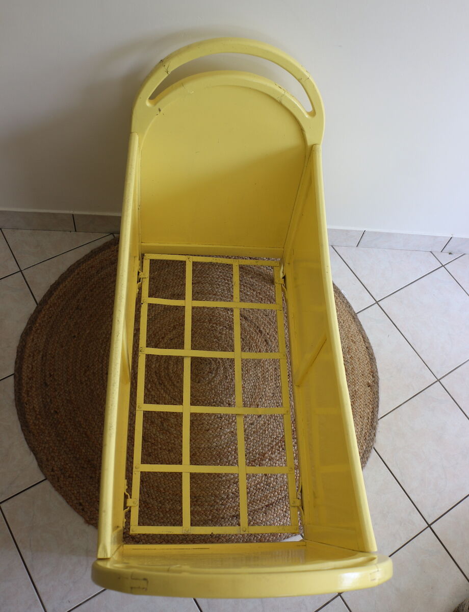 Yellow vintage baby cot