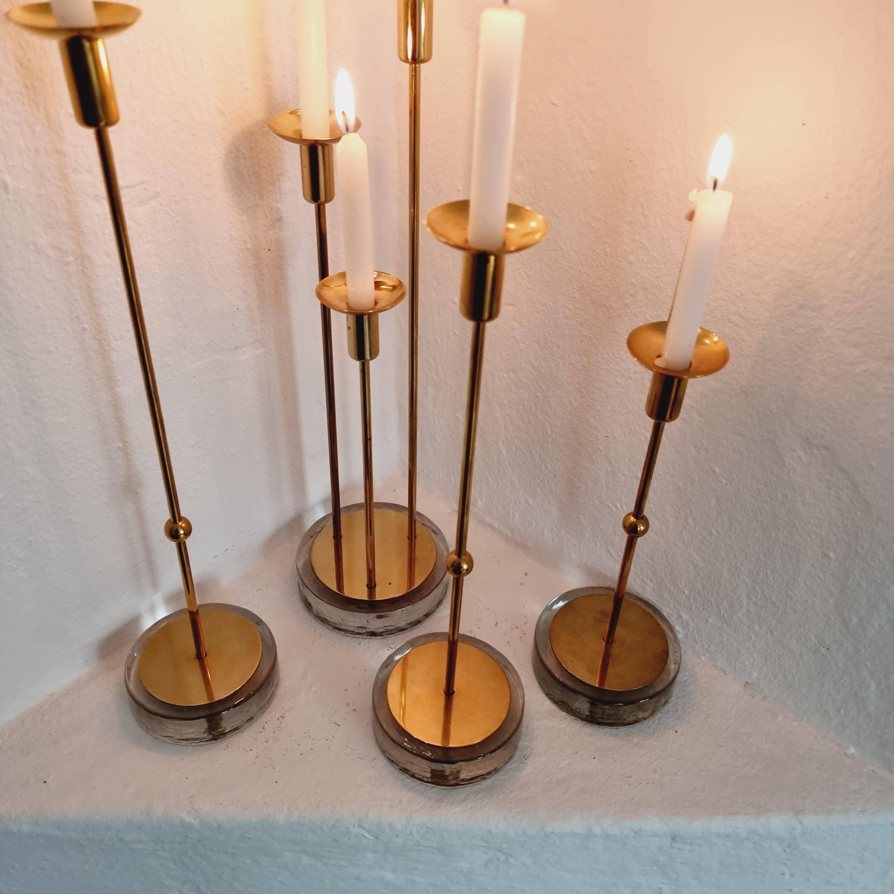 Gunnar Ander, four candlesticks, brass and glass, Ystad Metall, Swedish modern.