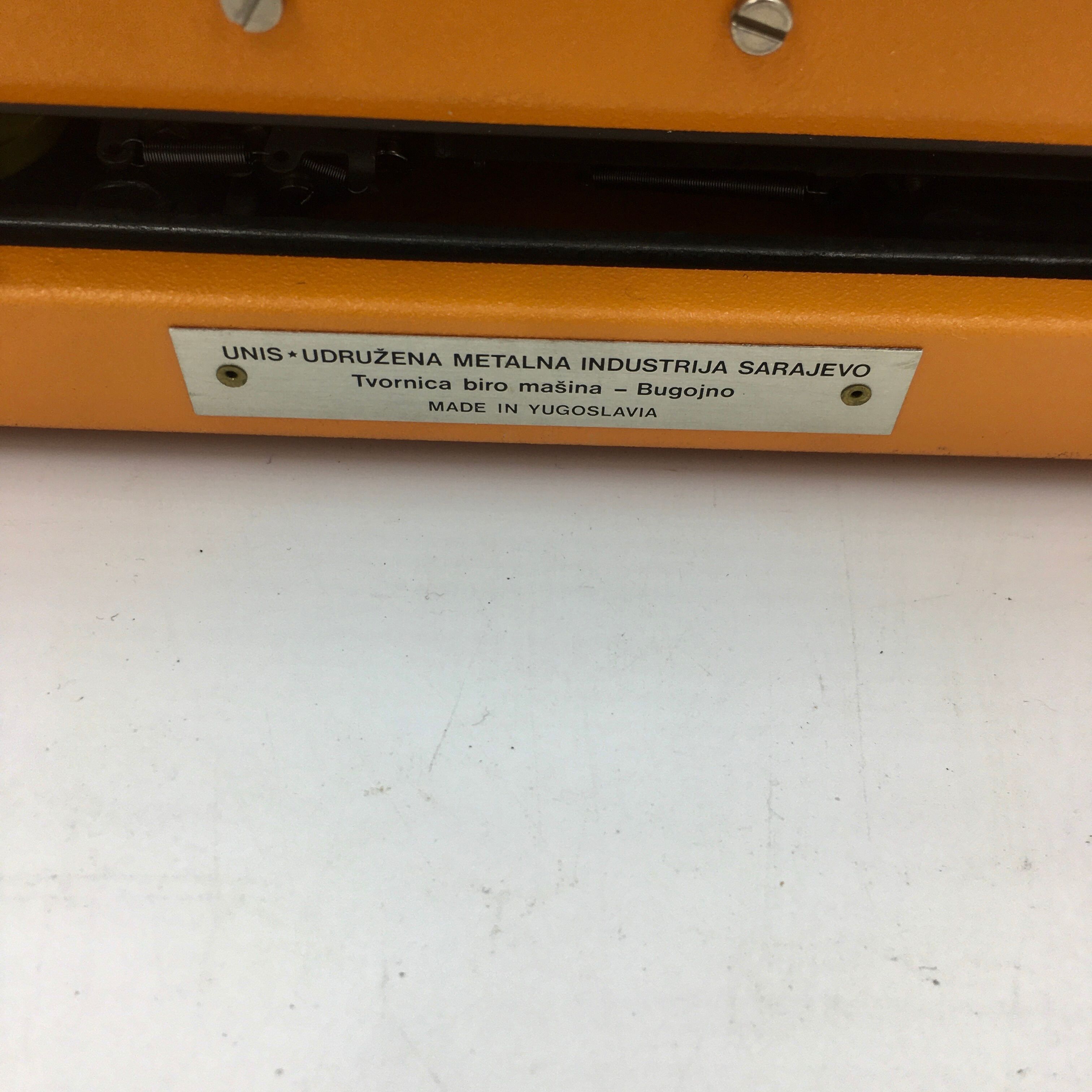 WE typewriter orange