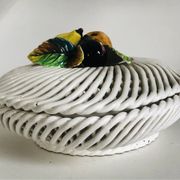 Covered basket in white woven ceramic and fruit slip.