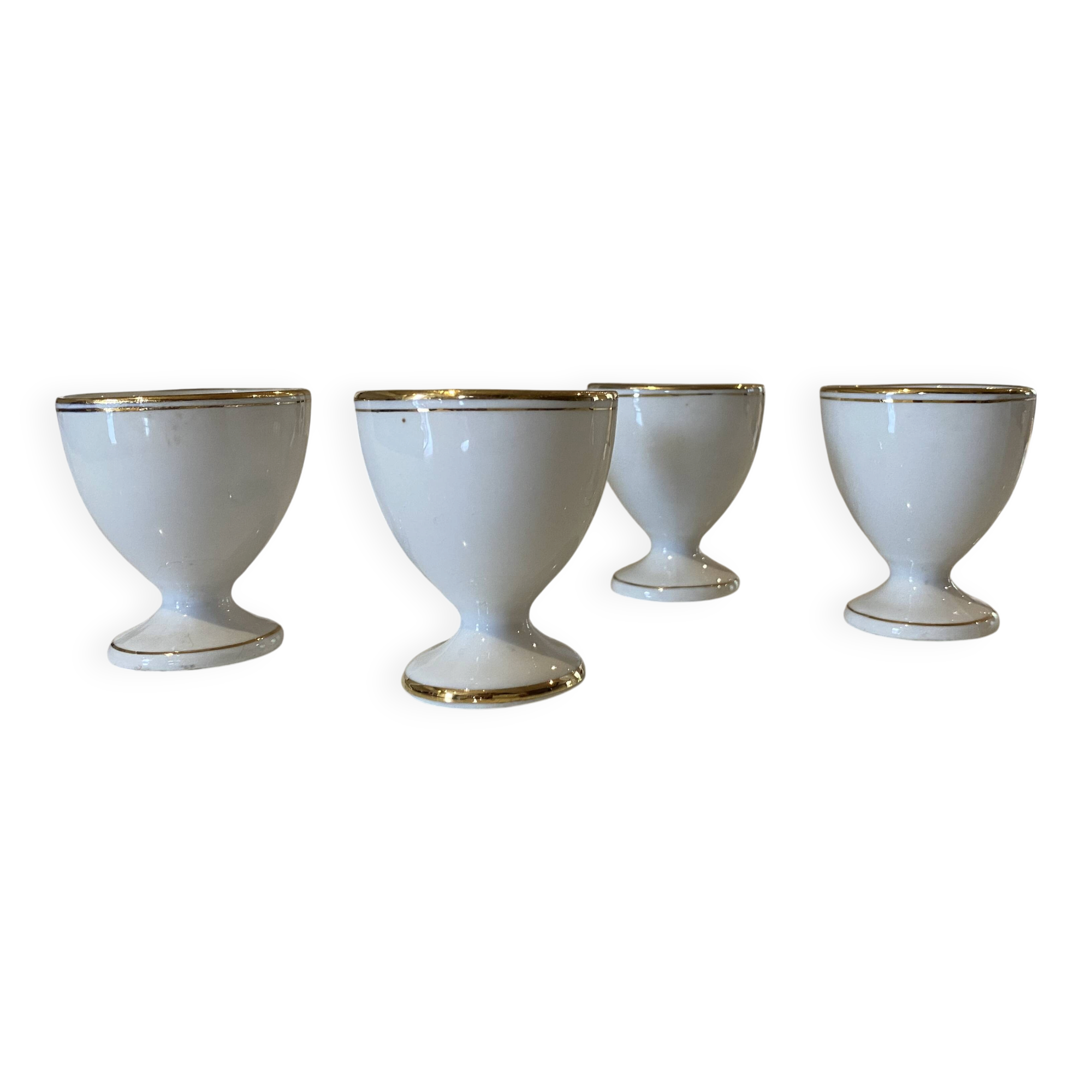 Set of 4 vintage egg cups in white porcelain with a gold rim.