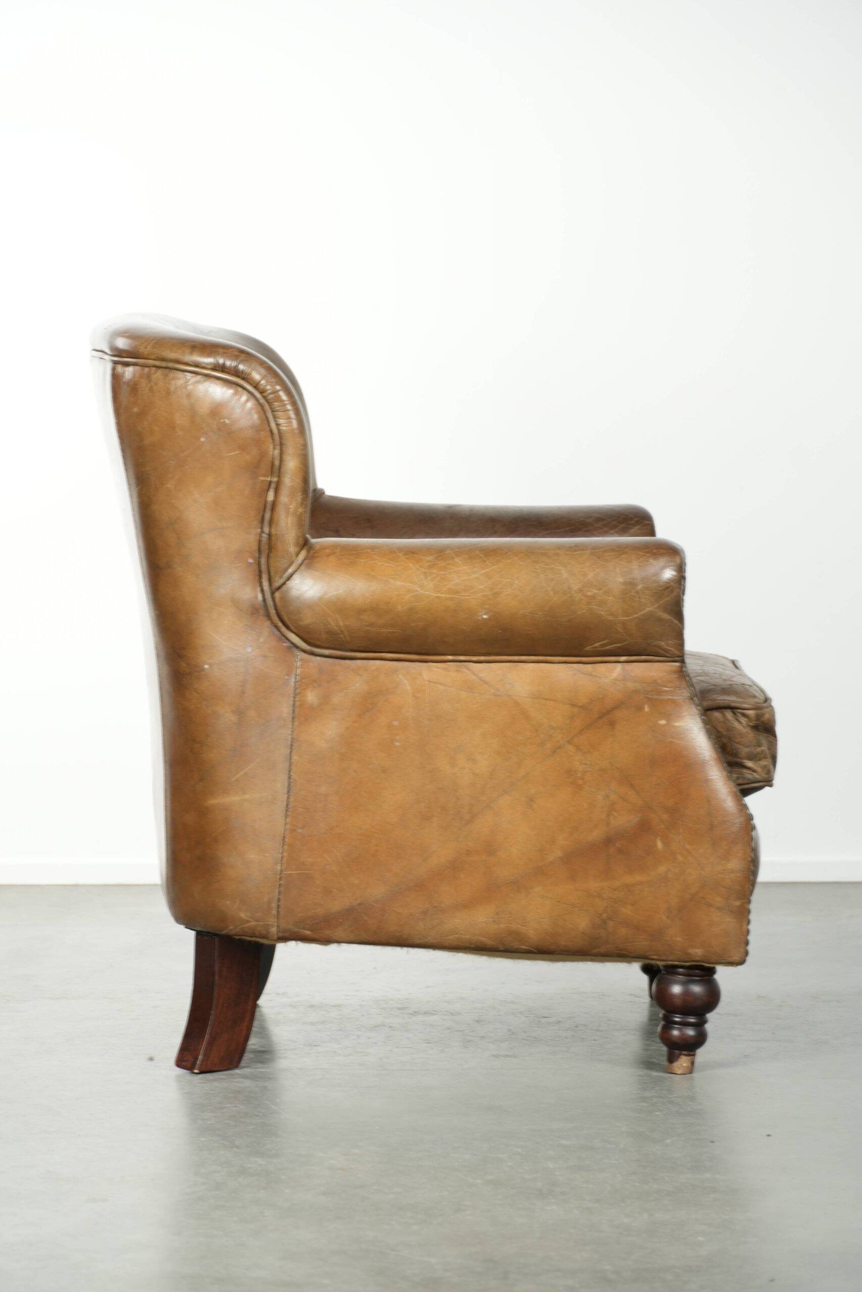 Robust cowhide armchair in a beautifully subtle size with a wonderful patina.