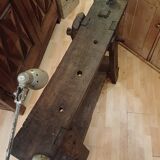 Small, very old, brutalist workbench equipped with a period workshop lamp