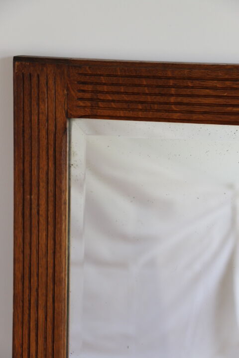 Beveled mirror grooved wood