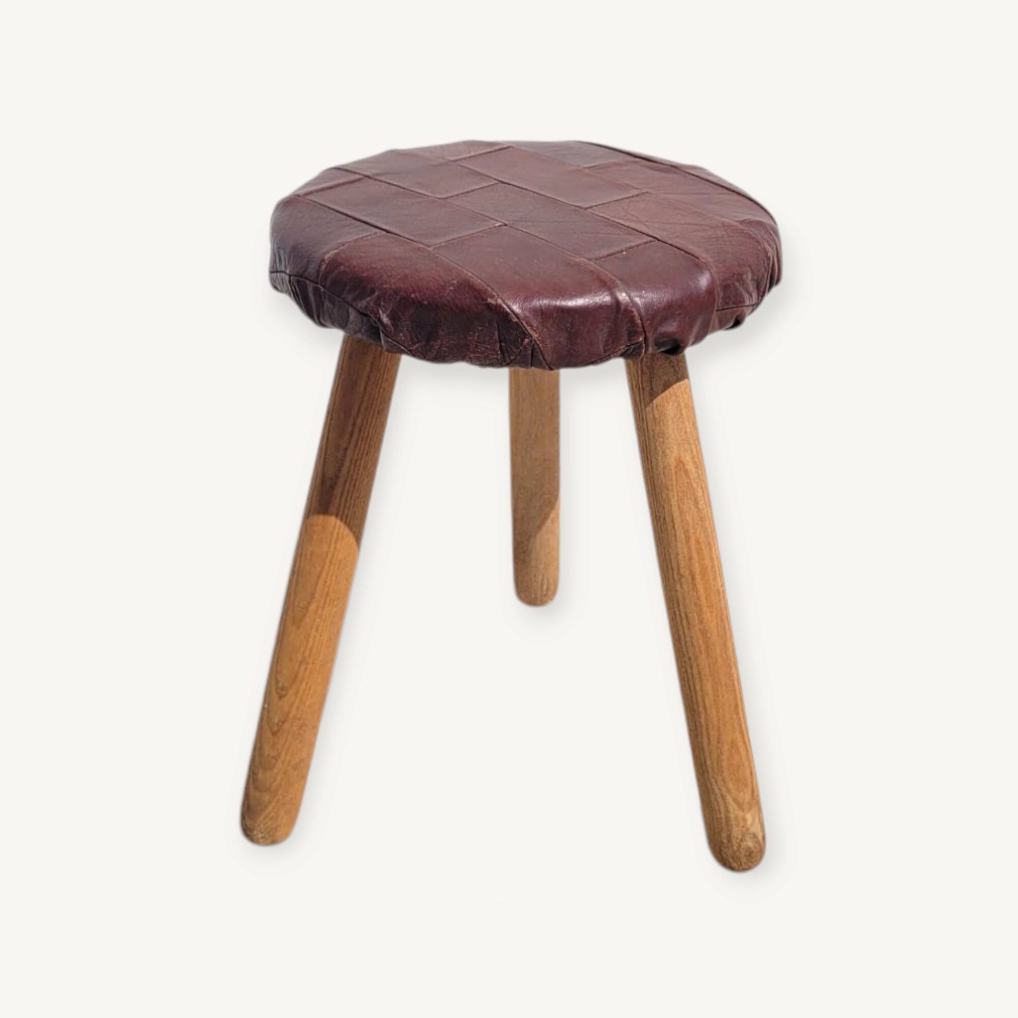 Leather-upholstered tripod stool