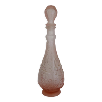 Old pink glass carafe decorated with fruits