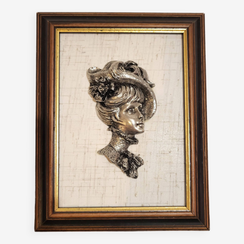 Elegant female bust in pewter on painting