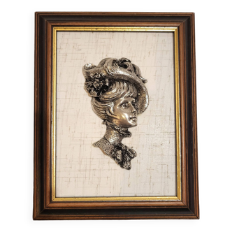 Elegant female bust in pewter on painting