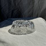 Circular glass ashtray with stylized petal patterns