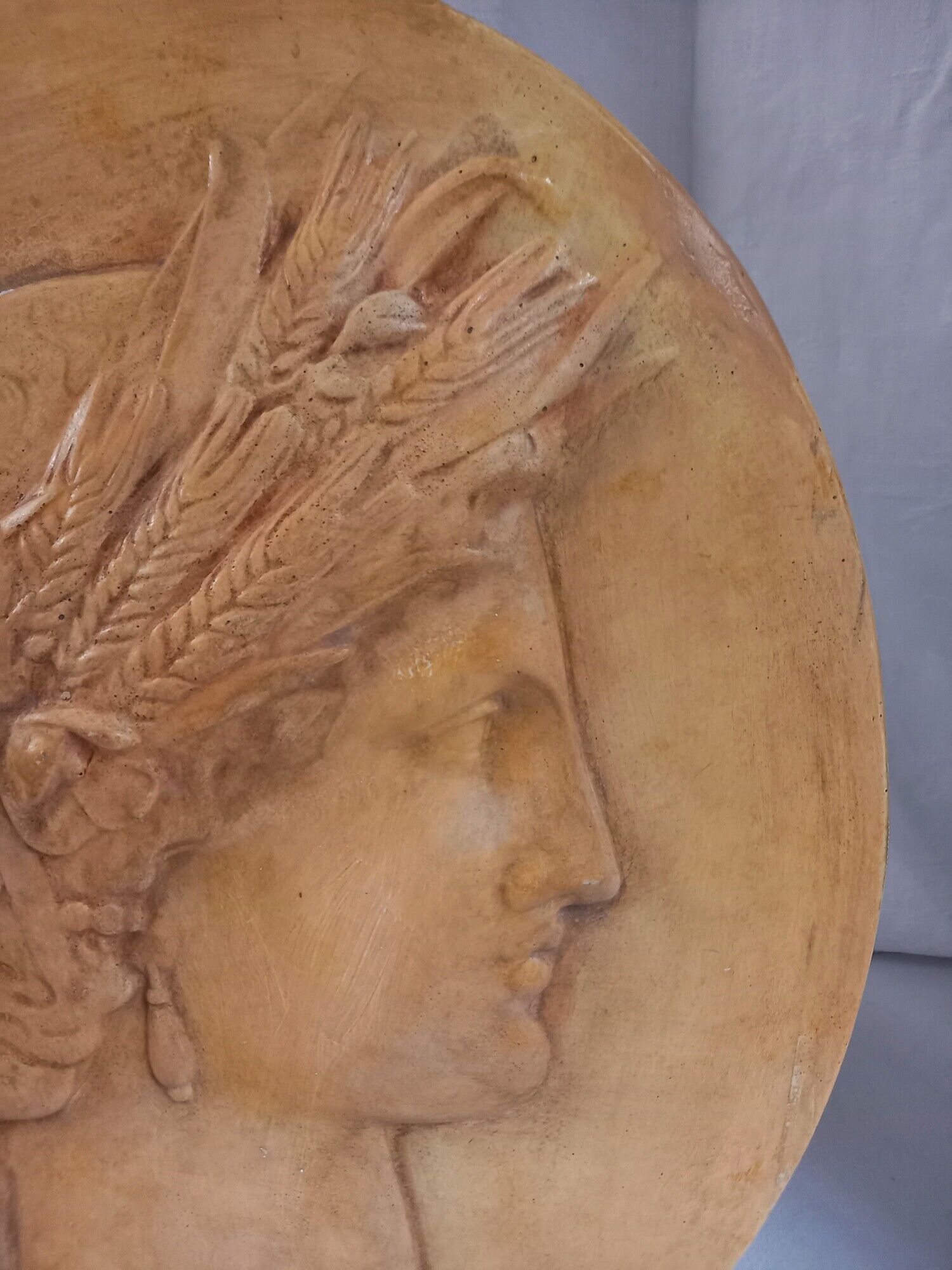 Plaster medallion, high relief, yellow ochre patina, representing the Roman divinity Ceres