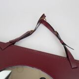 Mirror covered in burgundy leather