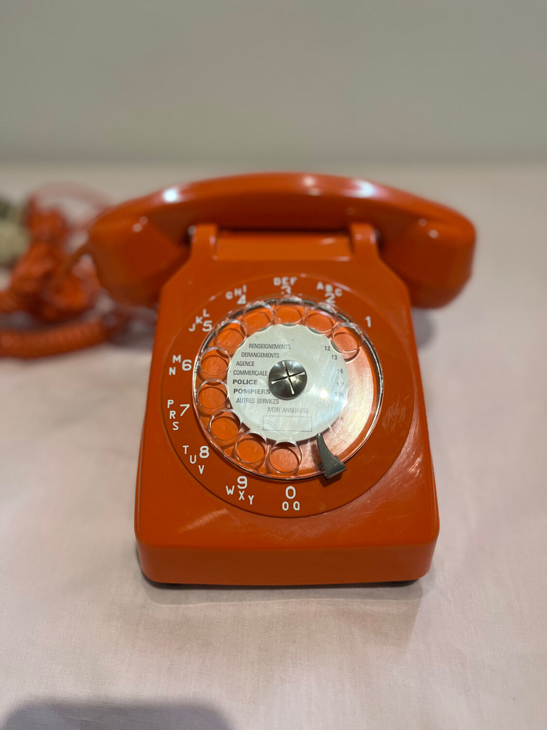 Orange vintage phone with socotel dial