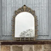 Vintage brass wall mirror adorned